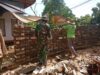 Babinsa Bantu Warga Bangun Pagar Rumah di Desa Basoka