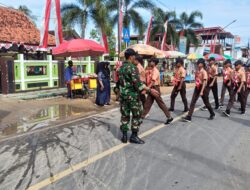 Babinsa Ambunten Amankan Lomba Gerak Jalan Tingkat Sekolah